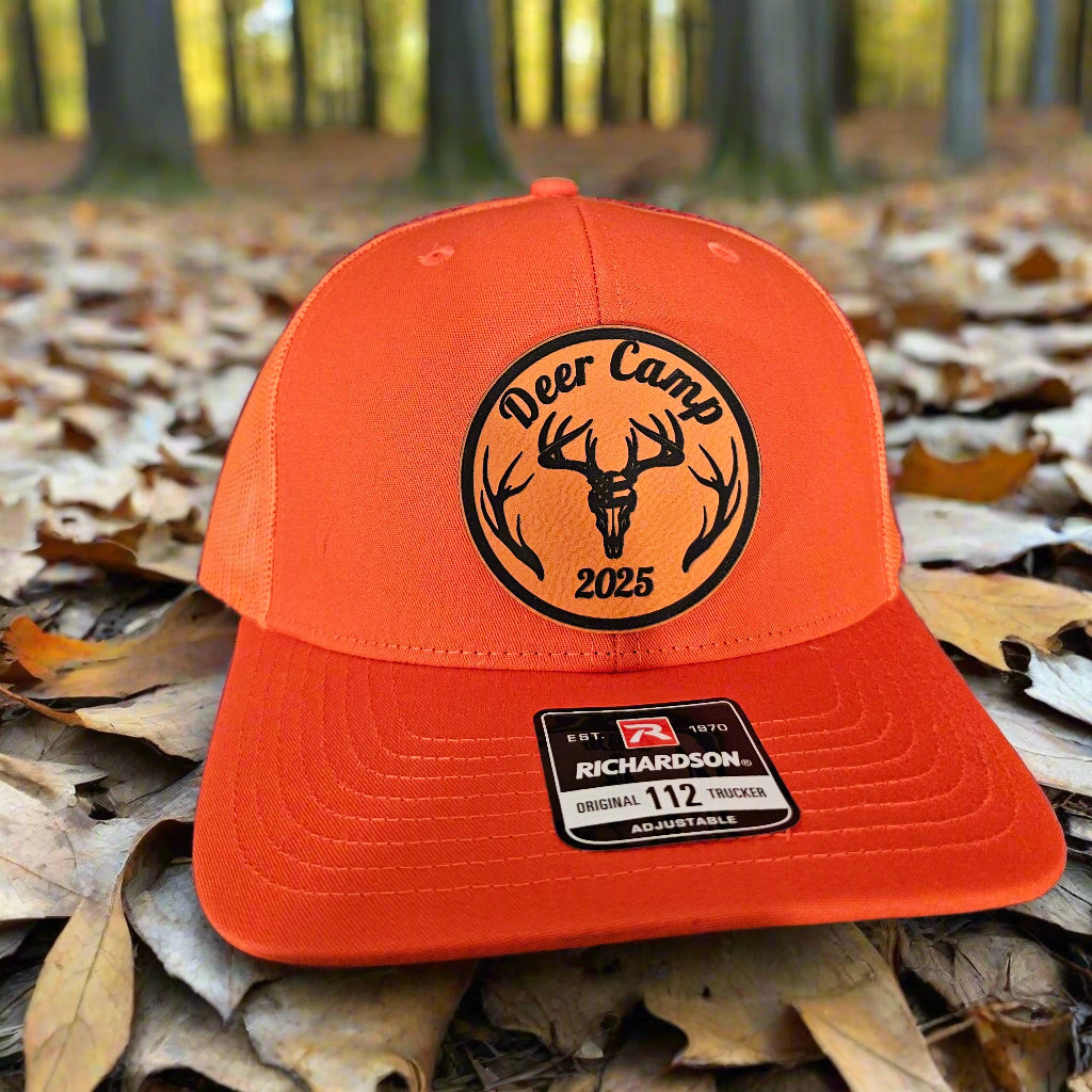 Orange cap with a logo and brand label on a textured surface