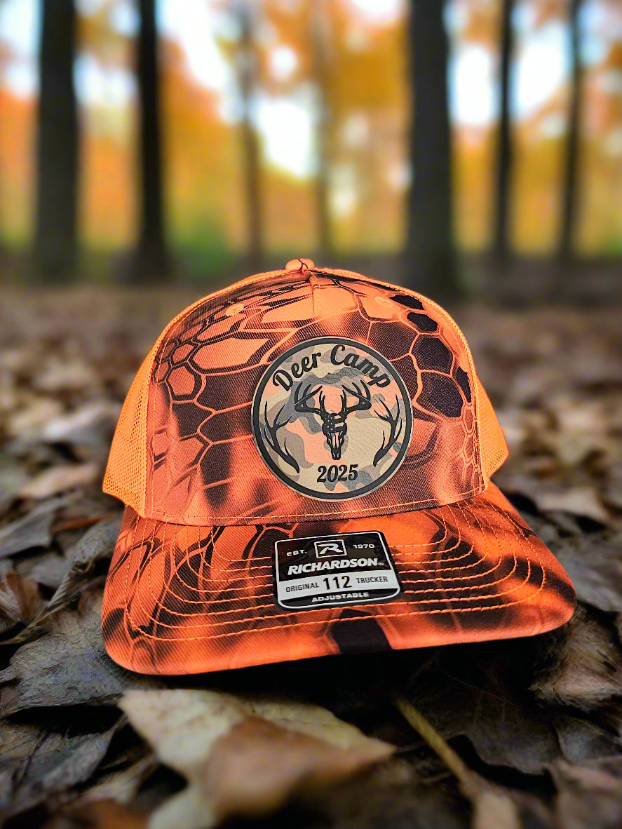 Orange hunting glove with a logo on a gray surface