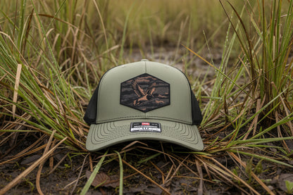 Green cap with a logo on a textured surface