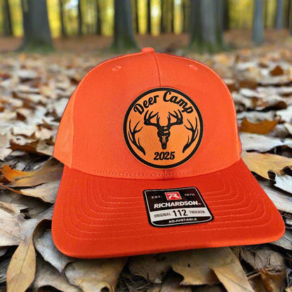 Orange cap with a logo and brand label on a textured surface